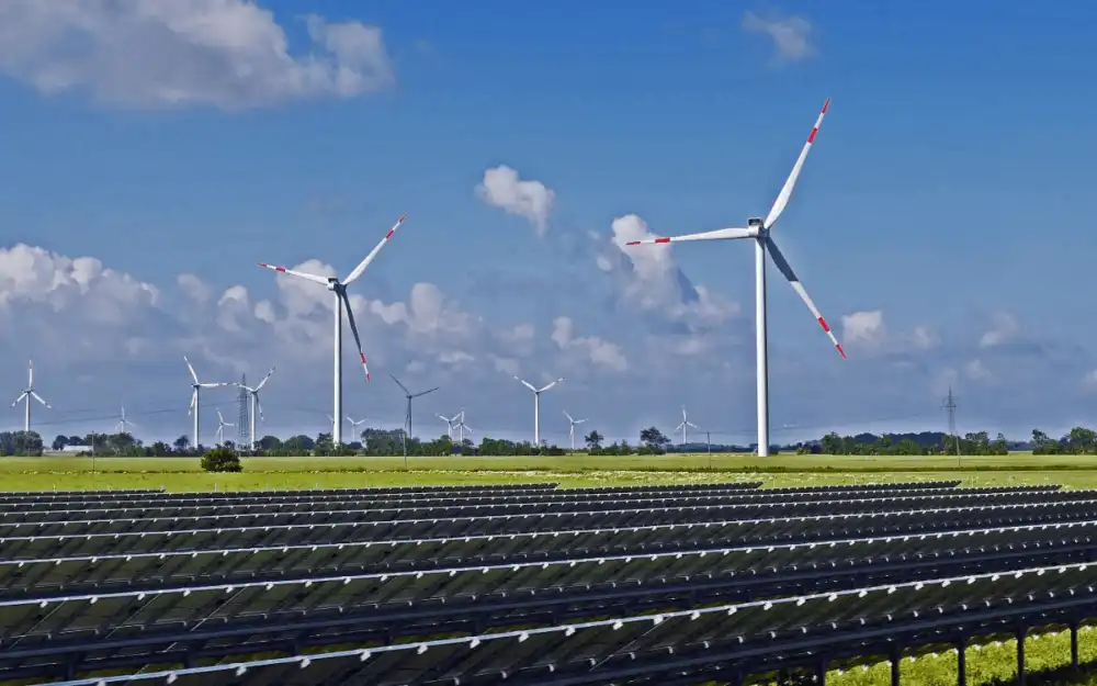 Aerial view of a large solar farm with rows of photovoltaic panels, representing the 2025 global milestone where renewable energy overtook coal in global electricity generation for the first time since approximately 1919