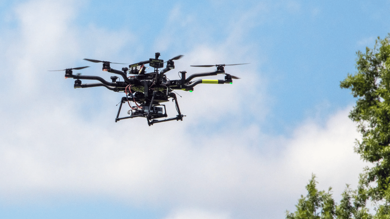 An Alta-8 small Unmanned Aircraft System testbed vehicle flies above NASA’s Langley Research Center in Hampton, Virginia. Flying beyond visual line of sight from observers on the ground required special approval from the Federal Aviation Administration and NASA. NASA / Bowman