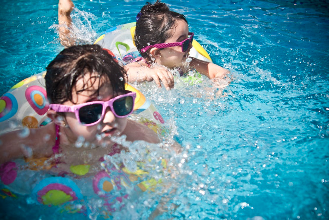 2 Girl's Swimming during Daytime trying to beat the heat. Photo Credit: Juan Salamanca, Pexels