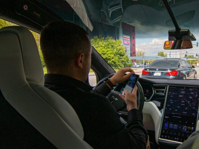 Man Driving a Tesla.