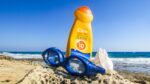 Representative image. Sunscreen, goggles, and seashell on a rocky beach. Photo Source: Dimitrisvetsikas1969 (Pixabay).