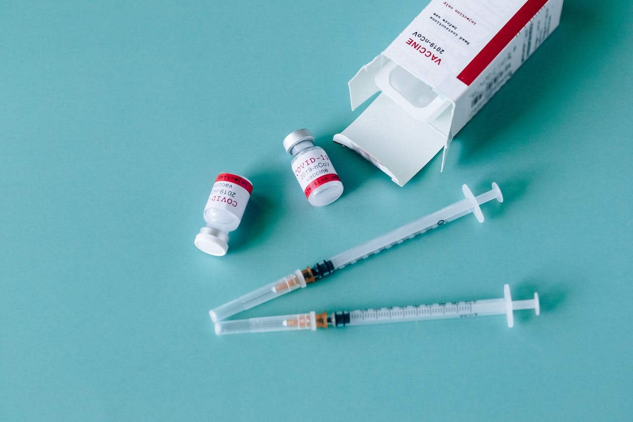 Representative Image. 2 vials labeled "COVID-19 Vaccine" accompanied by two syringes, Photo Source - Nataliya Vaitkevich (CC0 1.0)