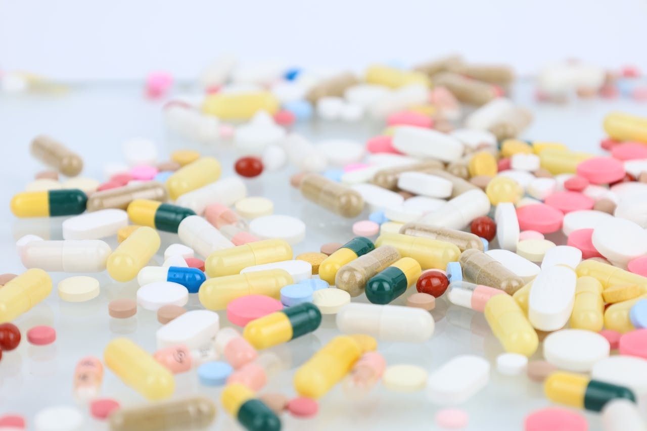 Representative Image. A diverse collection of pills and capsules, scattered across a surface. Photo Source - Lech Pierchala (CCO 1.0)