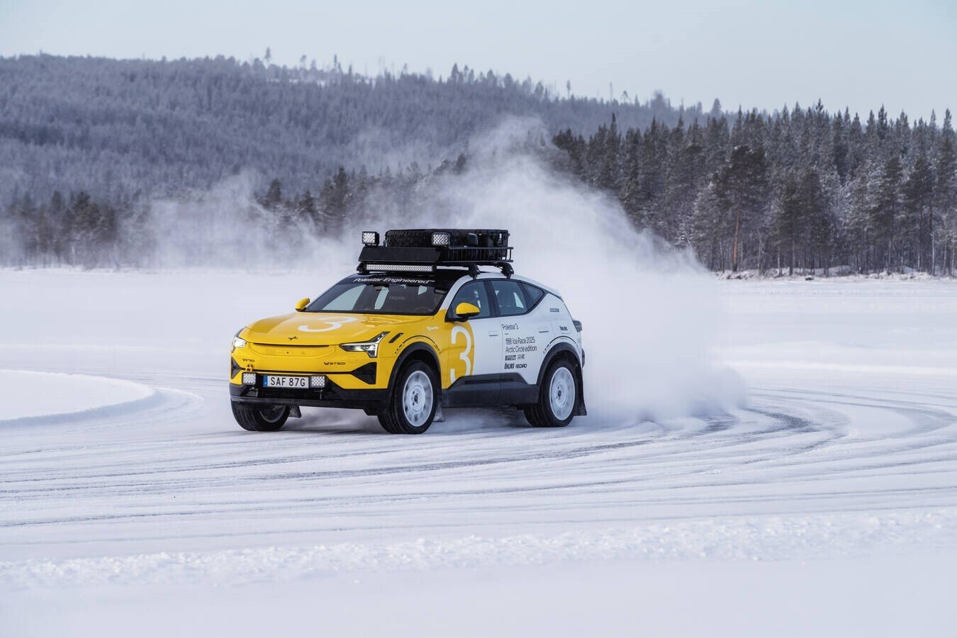 A yellow car in motion on a snowy terrain. Photo Source - Polestar