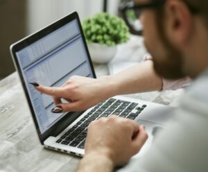 Representative Image: Person Pointing Finger on Laptop Screen. Photo Source: Mikhail Nilov (Pexels)