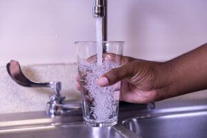 fetching water in glass from tap