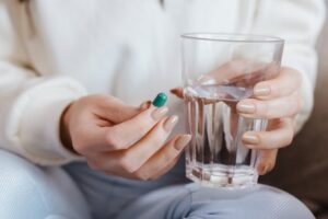 Representative Image: Woman Holding Pill and Glass of Water. Photo Source: Jonathan Borba (Pexels)