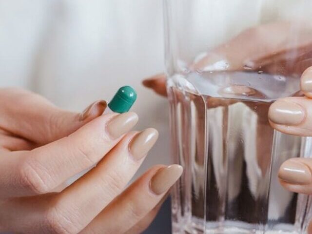 Representative Image: Woman Holding Pill and Glass of Water. Photo Source: Jonathan Borba (Pexels)
