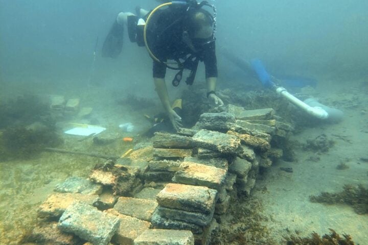 Marine archaeologist and research professor David Gregory from the National Museum of Denmark at piled bricks on the seabed in Costa Rica. Photo Source: Jakob Olling, The National Museum of Denmark