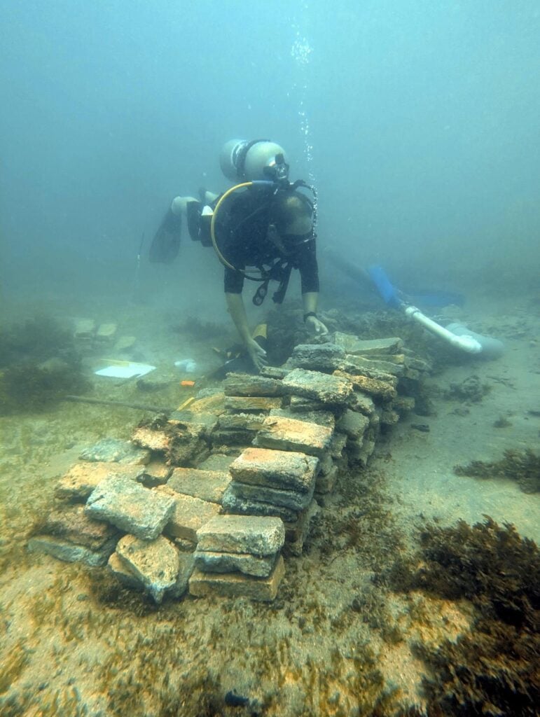 Marine archaeologist and research professor David Gregory from the National Museum of Denmark at piled bricks on the seabed in Costa Rica. Photo Source: Jakob Olling, The National Museum of Denmark