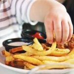 Child Reachig for Fries. Photo Source: Candance McDaniel