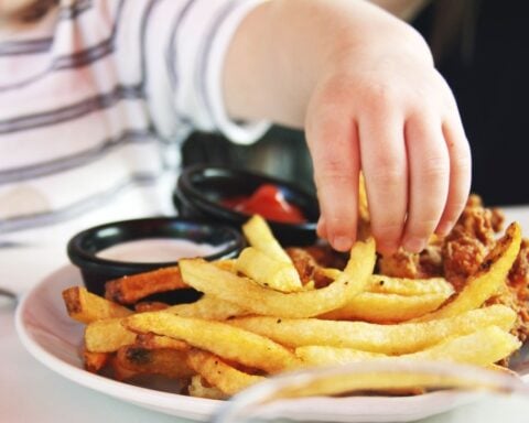 Child Reachig for Fries. Photo Source: Candance McDaniel