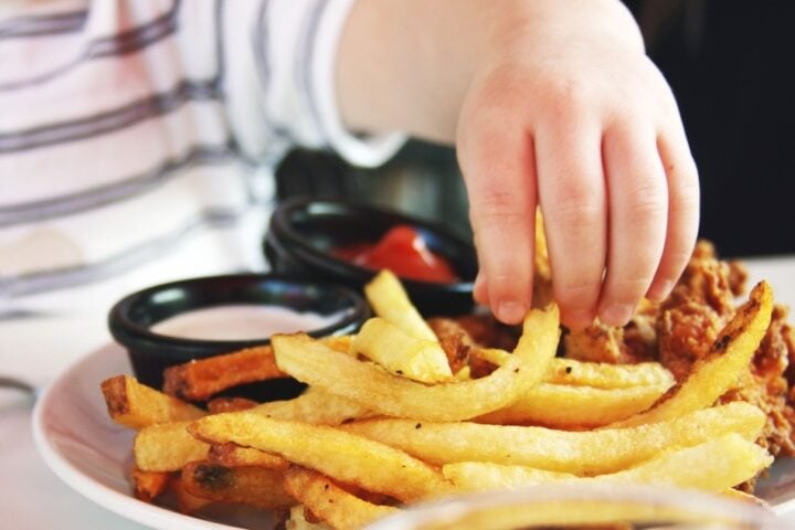 Child Reachig for Fries. Photo Source: Candance McDaniel