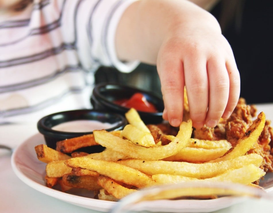 Child Reachig for Fries. Photo Source: Candance McDaniel