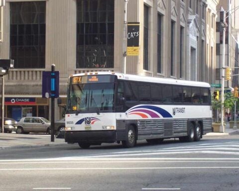 New Jersey Transit MCI #9035, in Newark, New Jersey at Broad Street and Raymond Boulevard on the 67X. Image Source: Adam E. Moreira (CC BY-SA 3.0 US)