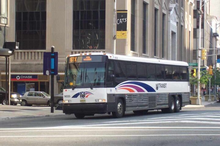 New Jersey Transit MCI #9035, in Newark, New Jersey at Broad Street and Raymond Boulevard on the 67X. Image Source: Adam E. Moreira (CC BY-SA 3.0 US)