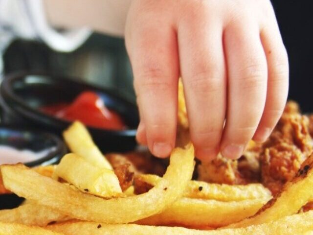 Child Reachig for Fries. Photo Source: Candance McDaniel