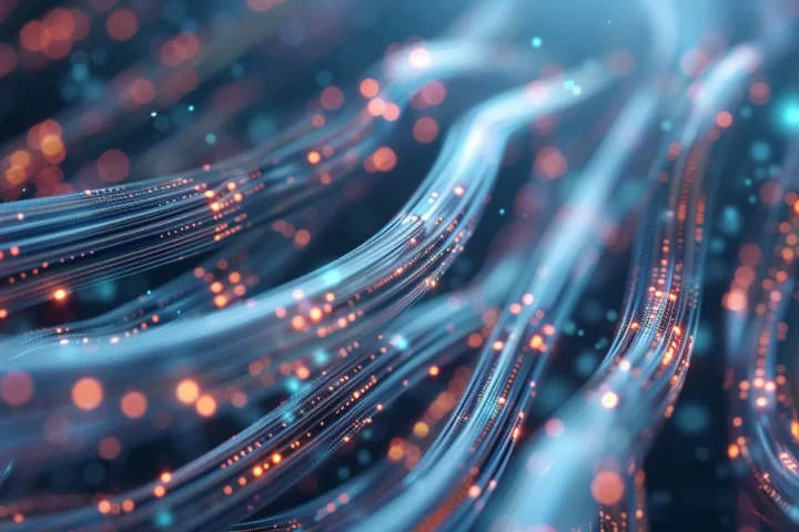 A mesmerizing close-up view of fiber optics showcasing glowing, swirling cables with vibrant light dots.