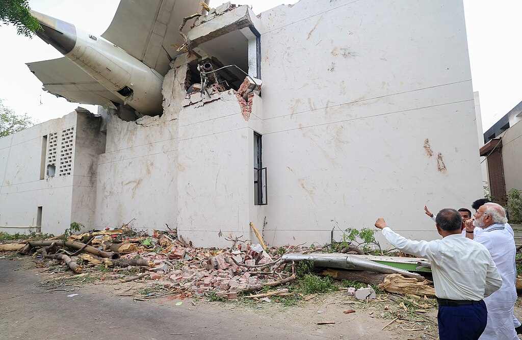 Prime Minister of Bharat, Shri Narendra Damodardas Modi looks on at the wreckage of the crashed Air India Flight 171