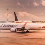 White American Airlines aircraft parked on the runway at Paris Charles de Gaulle Airport during daylight.