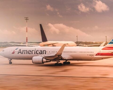 White American Airlines aircraft parked on the runway at Paris Charles de Gaulle Airport during daylight.