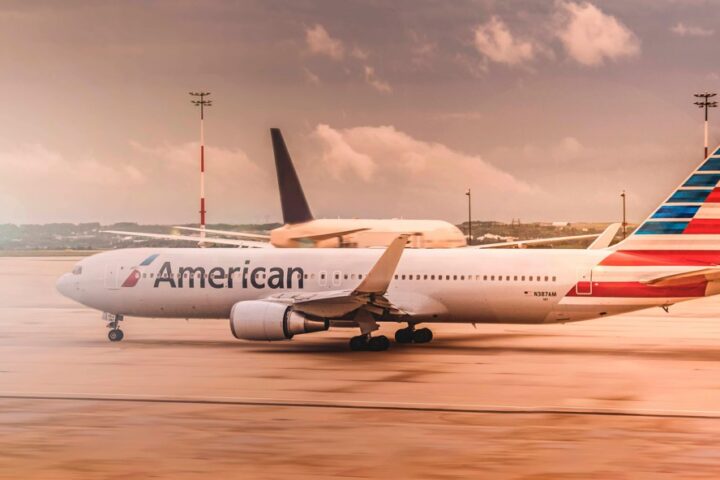 White American Airlines aircraft parked on the runway at Paris Charles de Gaulle Airport during daylight.
