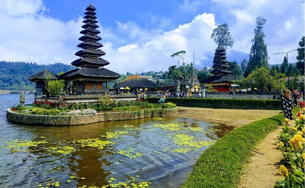 Traditional Balinese temple gate with twin stone towers against a clear blue sky in Bali, Indonesia.