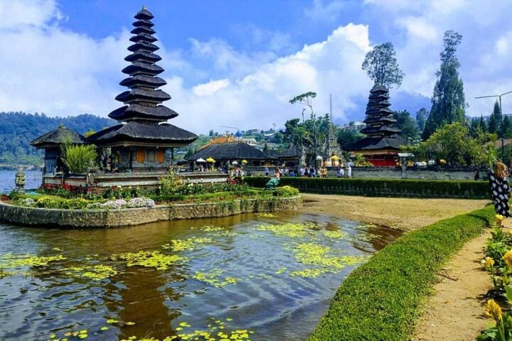 Traditional Balinese temple gate with twin stone towers against a clear blue sky in Bali, Indonesia.