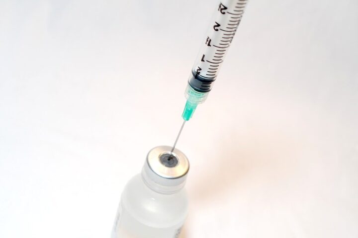 Needle syringe with a vaccine bottle. Photo Source: NIH
