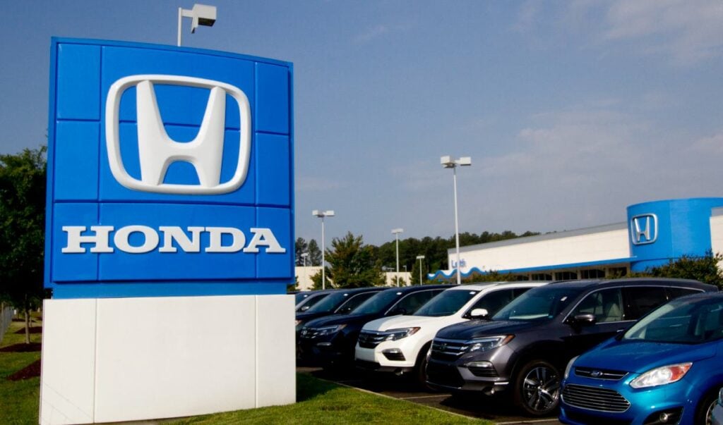 A photograph of the Honda sign at a car dealership.