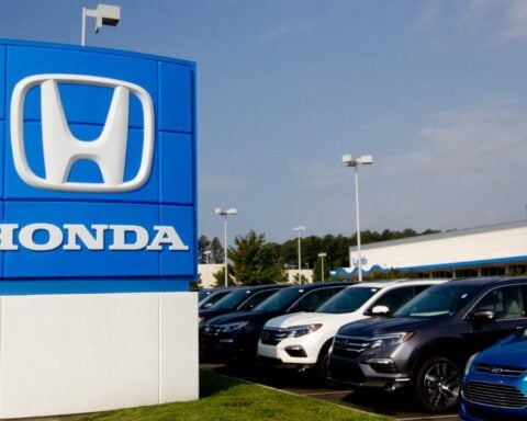 A photograph of the Honda sign at a car dealership.