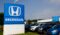 A photograph of the Honda sign at a car dealership.