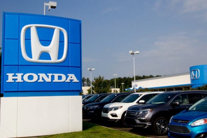 A photograph of the Honda sign at a car dealership.