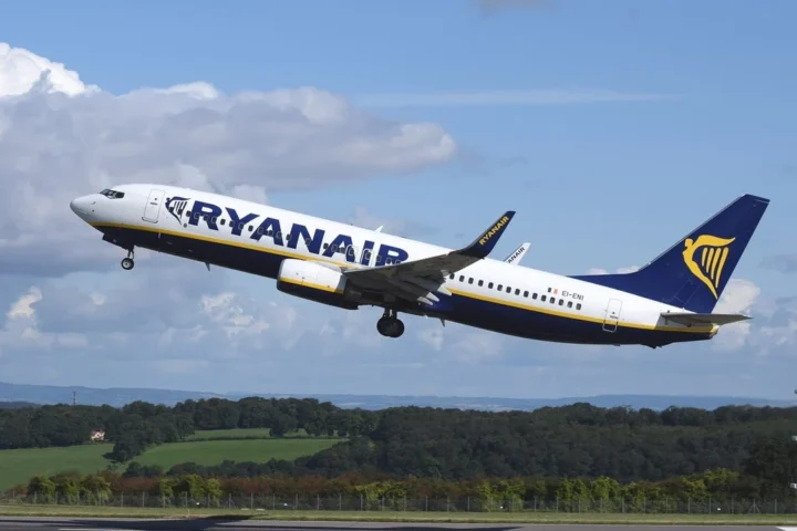 A large passenger jet taking off from an airport runway. Airplane aircraft commercial.