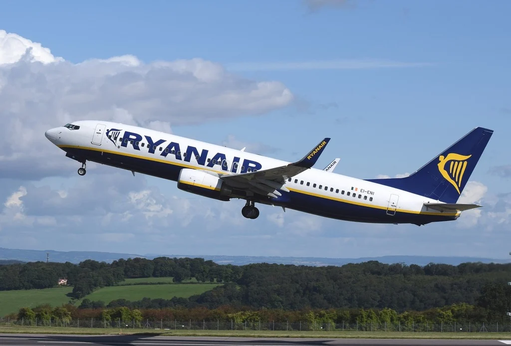 A large passenger jet taking off from an airport runway. Airplane aircraft commercial.