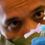 SPC Anthony Ariola prepares a dose of the Covid vaccine Photo Source: DVID Service