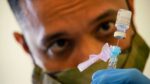 SPC Anthony Ariola prepares a dose of the Covid vaccine Photo Source: DVID Service