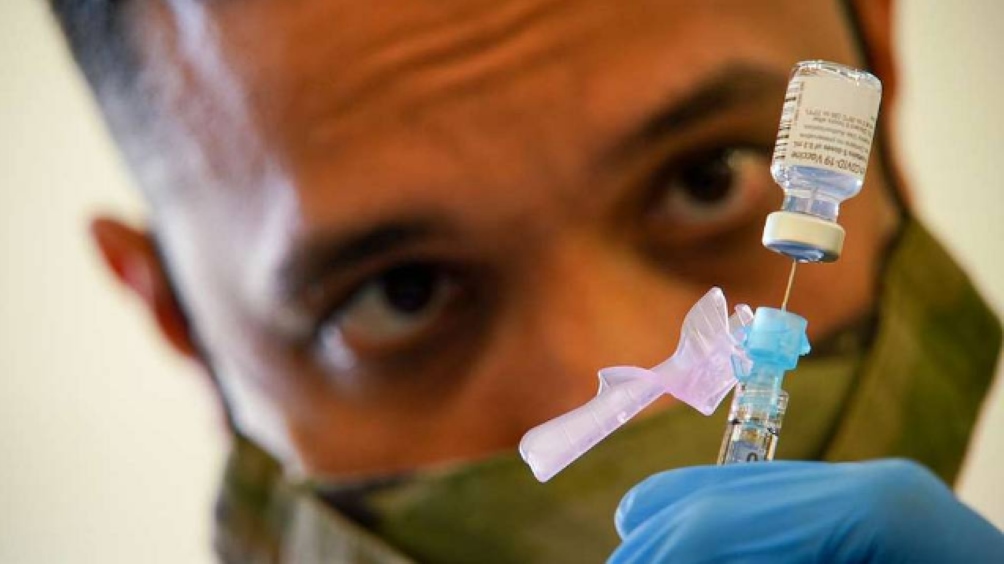 SPC Anthony Ariola prepares a dose of the Covid vaccine Photo Source: DVID Service