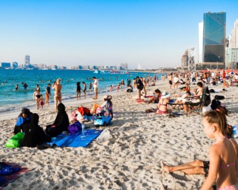 Beach blue sky buildings children Dubai enjoyment fun group Photo Source: PxHere