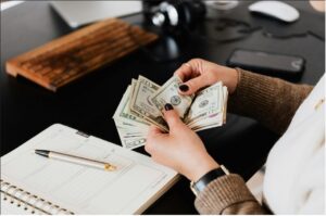 Close-up of women counting us dollar.