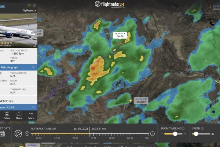 Flightradar24 map view at 23:23 UTC on July 30, 2025, showing Delta DL56’s flight path cutting through scattered green and yellow storm echoes over Wyoming and Minnesota.