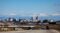 Alt Text: Downtown Fresno skyline with snow-capped Sierra Nevada mountains under a clear blue sky.