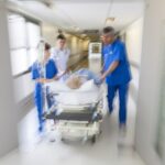 Representative Image: A patient on stretcher being pushed through a hospital corridor. Photo Source: PixHere
