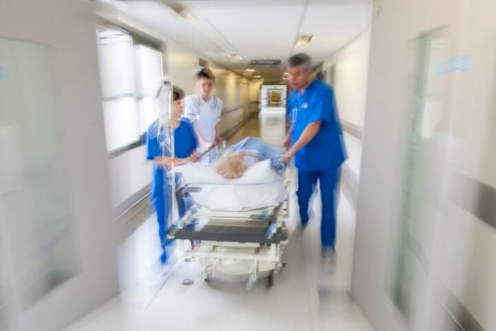 Representative Image: A patient on stretcher being pushed through a hospital corridor. Photo Source: PixHere
