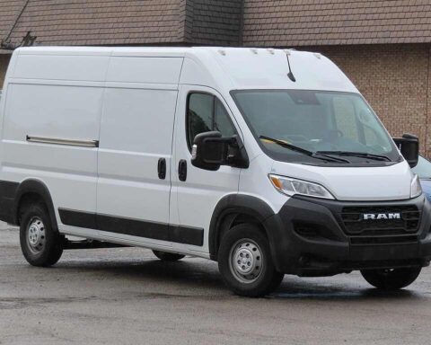 White 2023 Ram ProMaster 2500 cargo van with high roof and 159-inch wheelbase parked in front of brick building, showing front and side view of recalled commercial vehicle