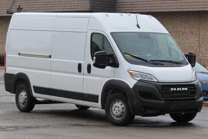 White 2023 Ram ProMaster 2500 cargo van with high roof and 159-inch wheelbase parked in front of brick building, showing front and side view of recalled commercial vehicle