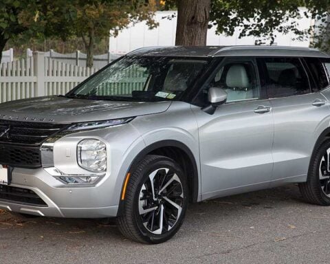 2022 Mitsubishi Outlander SEL 2.5 in Alloy Silver parked on street with white picket fence in background