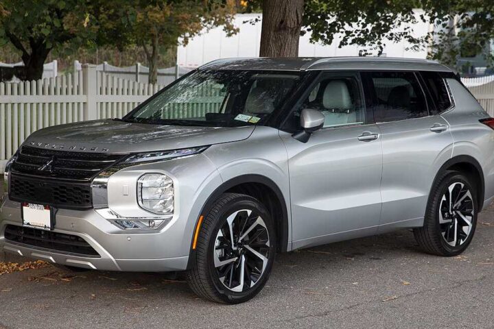 2022 Mitsubishi Outlander SEL 2.5 in Alloy Silver parked on street with white picket fence in background