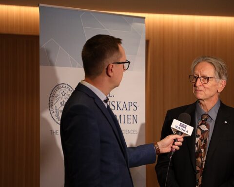 Geoffrey Hinton speaking at a Nobel Prize press conference, discussing unconventional AI safety approaches