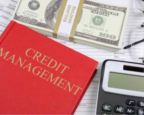 Red “Credit Management” book with calculator, glasses, hundred-dollar bills, and financial paperwork — symbolizing personal finance monitoring and credit score protection.